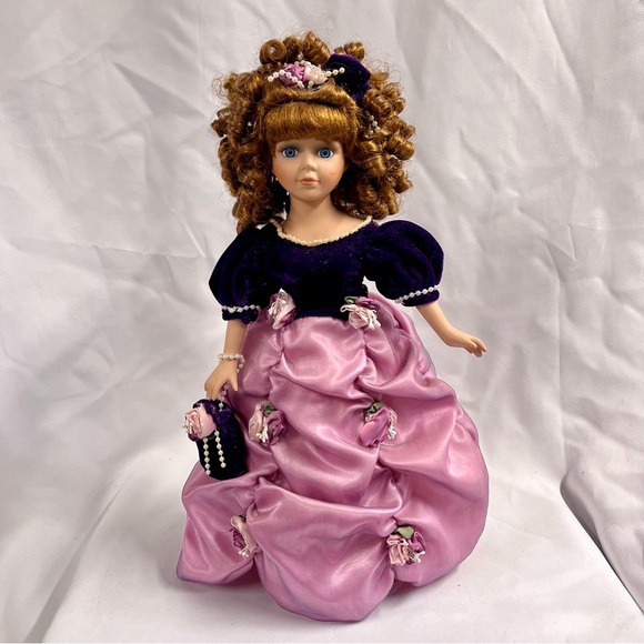 The Collectors Choice Porcelain Doll by DanDee/Purple Dress/Brown Hair/Blue Eyes The Collectors Choice Porcelain Doll by DanDee/Purple Dress/Brown Hair/Blue Eyes